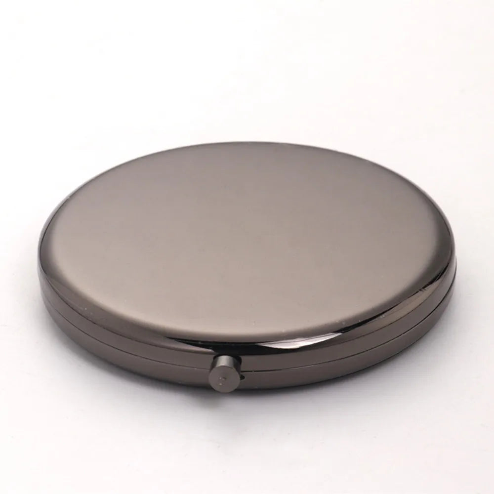 A round, metallic makeup mirror with a folding design and magnifier.