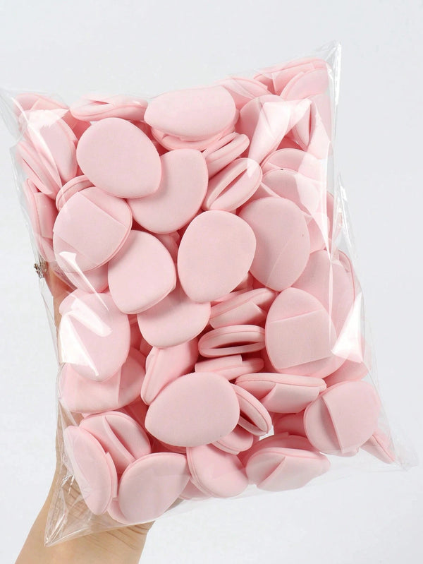 A clear plastic bag filled with pink latex-free finger puffs for makeup application.