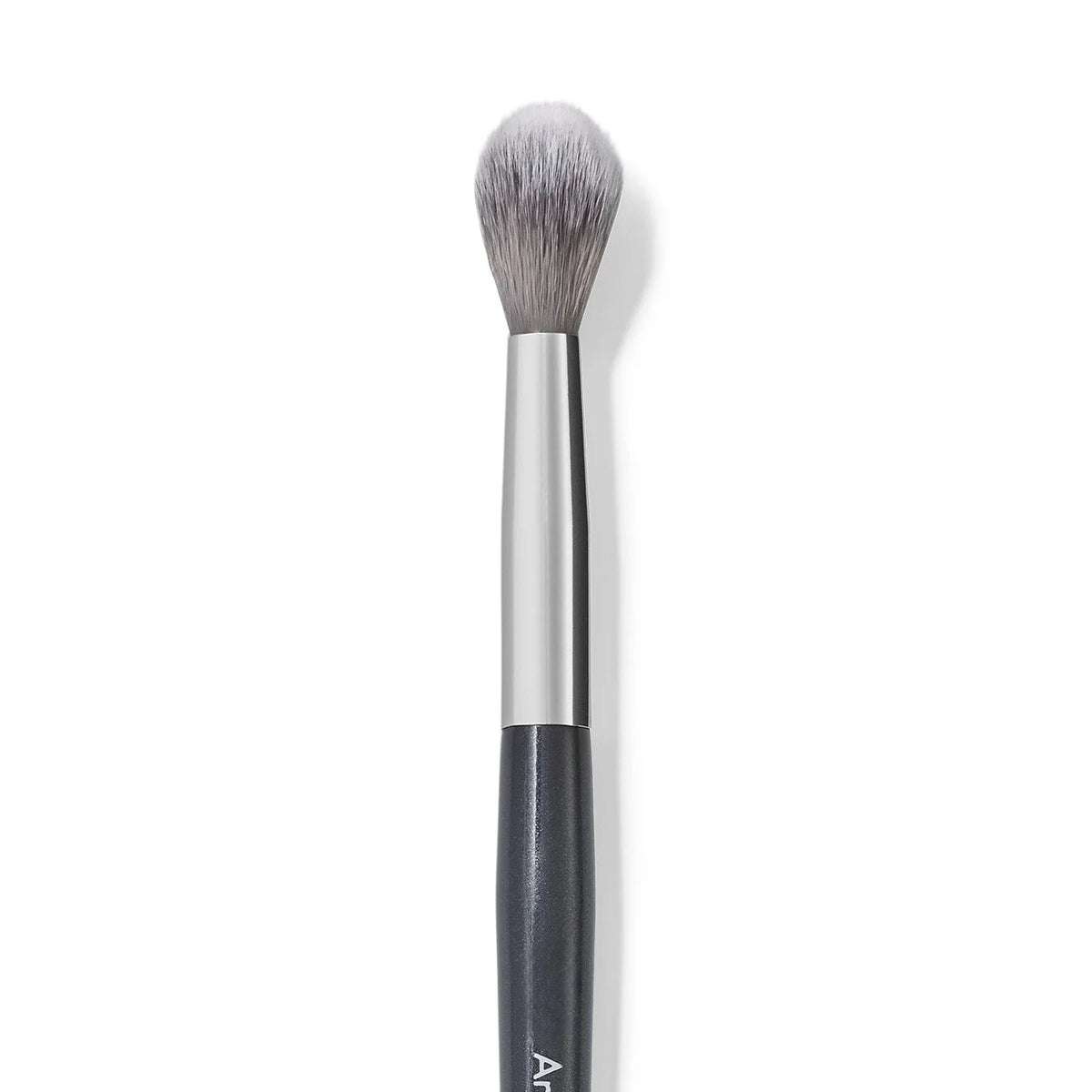 A silver and black precision concealer brush with a fluffy synthetic hair tip.