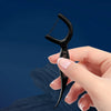 A hand holds a black bamboo charcoal dental floss stick, demonstrating the product.