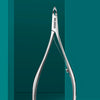 A pair of silver stainless steel cuticle nippers is displayed against a teal background.