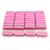 A row of pink and white nail buffing blocks arranged in rows.
