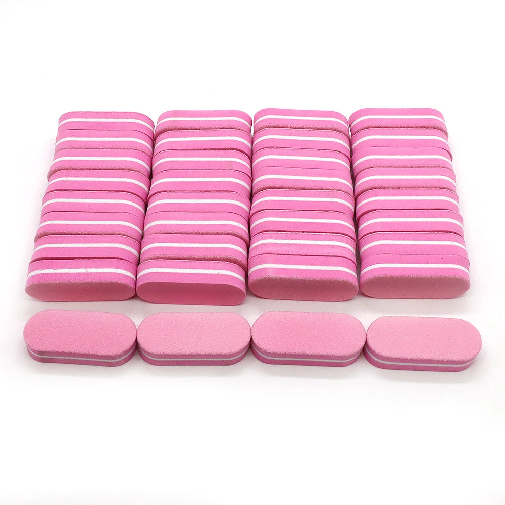 A row of pink and white nail buffing blocks arranged in rows.