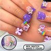 A hand displays a set of purple and pink press-on nails featuring leopard print designs and various 3D charms.