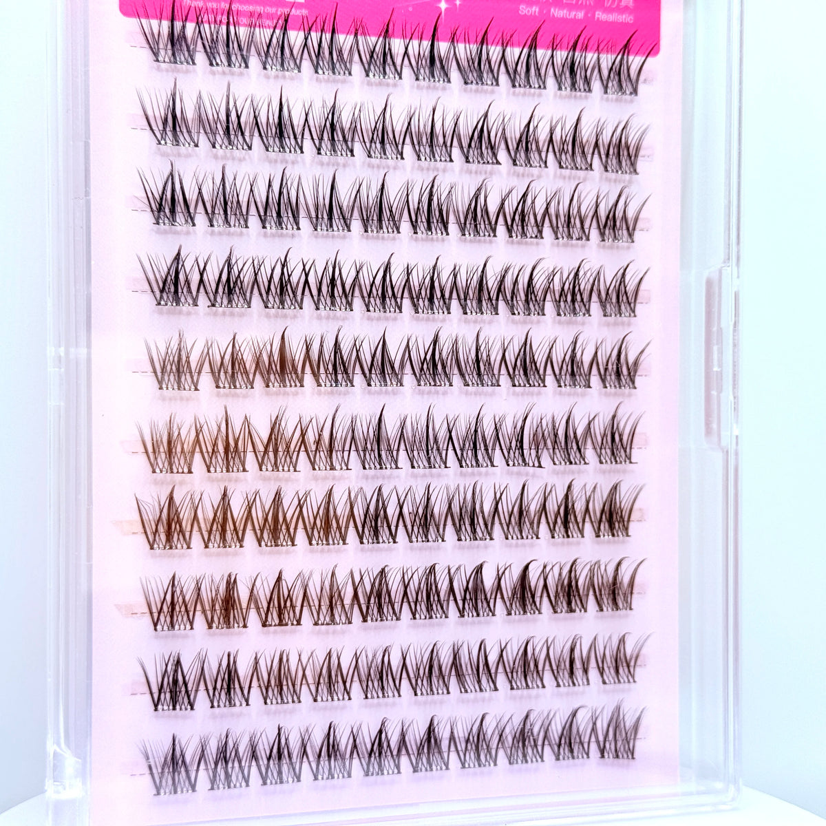 A display of adhesive-free natural look eyelash clusters in various lengths and shades.