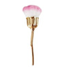 A gold-handled nail art dust brush with a pink and white fluffy brush head.