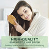 A woman is using a high-quality boar bristle hair brush to style her long, dark hair.