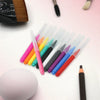 A collection of colorful mini brow and eyelash combs arranged on a white surface.
