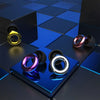 A close-up of reusable high-fidelity ear plugs in various colors resting on a dark, reflective grid surface.