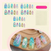 A collection of almond-shaped press-on nails in gradient blue and green colors displayed on a wooden surface.