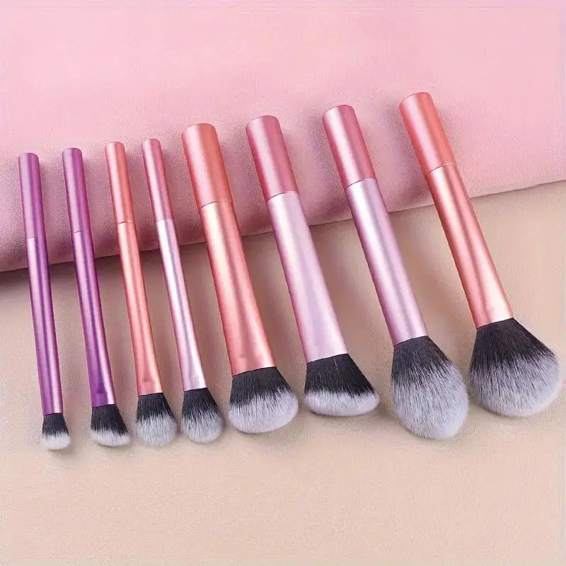 A set of eight pink and purple makeup brushes with fluffy silicone bristles displayed on a light background.