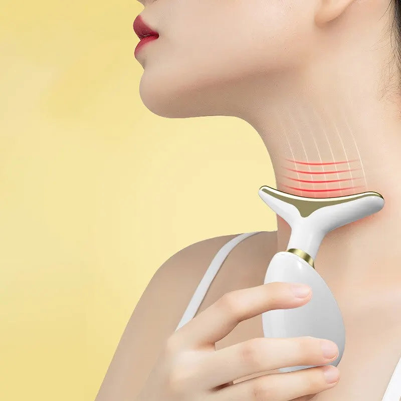A hand is applying an electric facial lifting and firming massager to the side of a woman's neck.