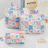A collection of pink and blue quilted cotton makeup bags featuring floral patterns and ribbon closures.