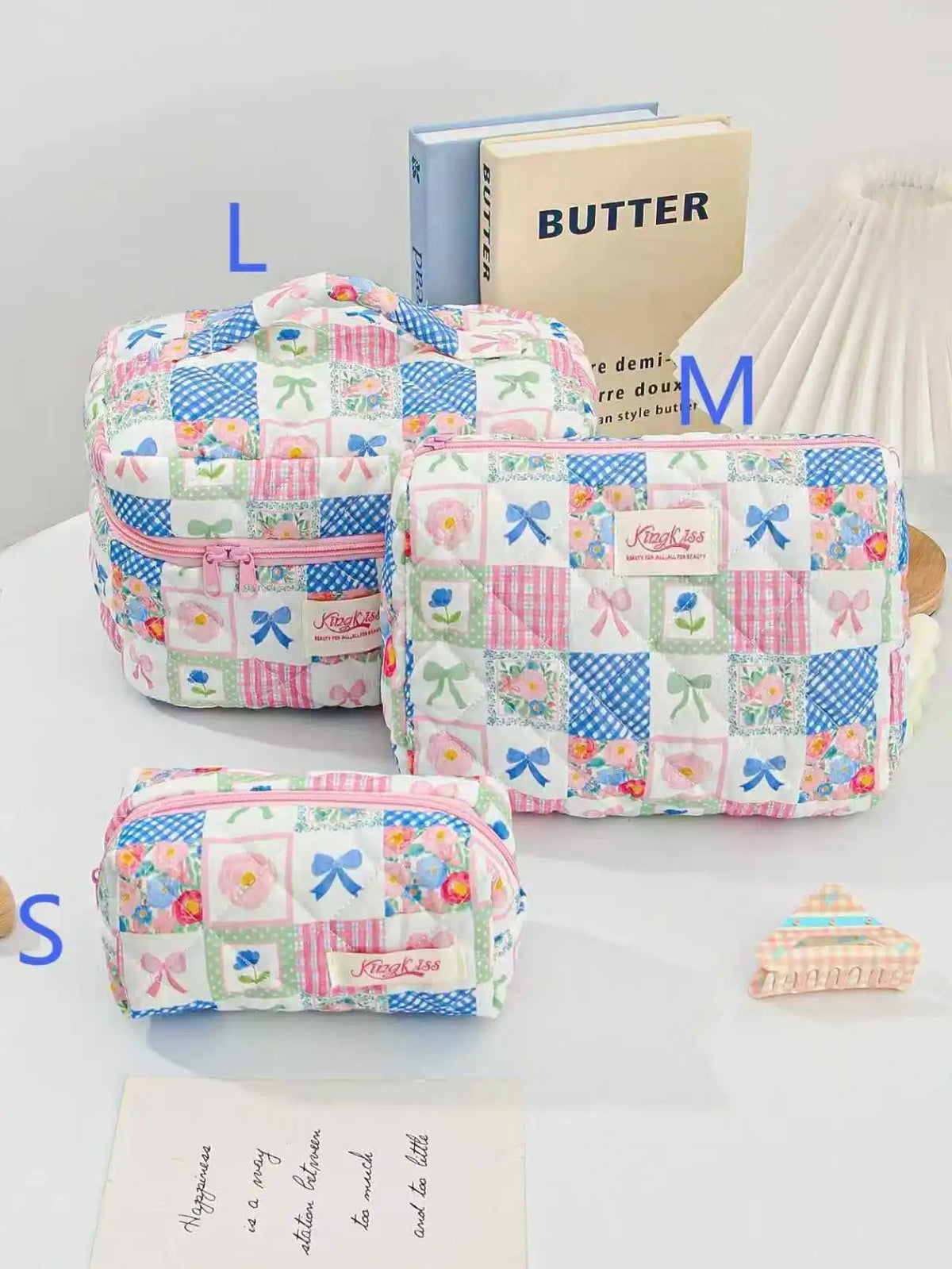 A collection of pink and blue quilted cotton makeup bags featuring floral patterns and ribbon closures.