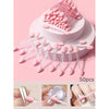 A set of pink double-sided nail art brushes with sponge applicators displayed on a white stand.