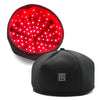 A black cap with a red light panel showing multiple bright LEDs for hair growth treatment.