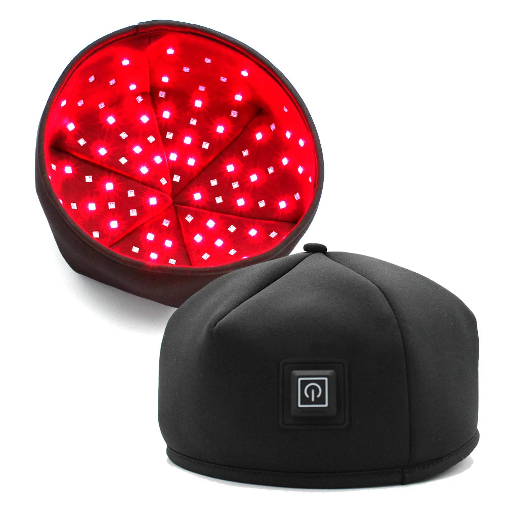 A black cap with a red light panel showing multiple bright LEDs for hair growth treatment.
