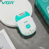 A white and teal rechargeable electric epilator device is shown on a gray surface next to its packaging box.
