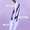 A close-up of a purple automatic curling iron with a heated barrel, showing features like automatic curling and heat protecti
