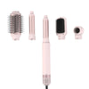Ein Set aus fünf abnehmbaren Haarbürsten zum Styling und Trocknen in rosa und silbernen Tönen.