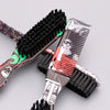 A pair of professional beard styling brushes with black bristles and decorative handles are shown on a gray background.