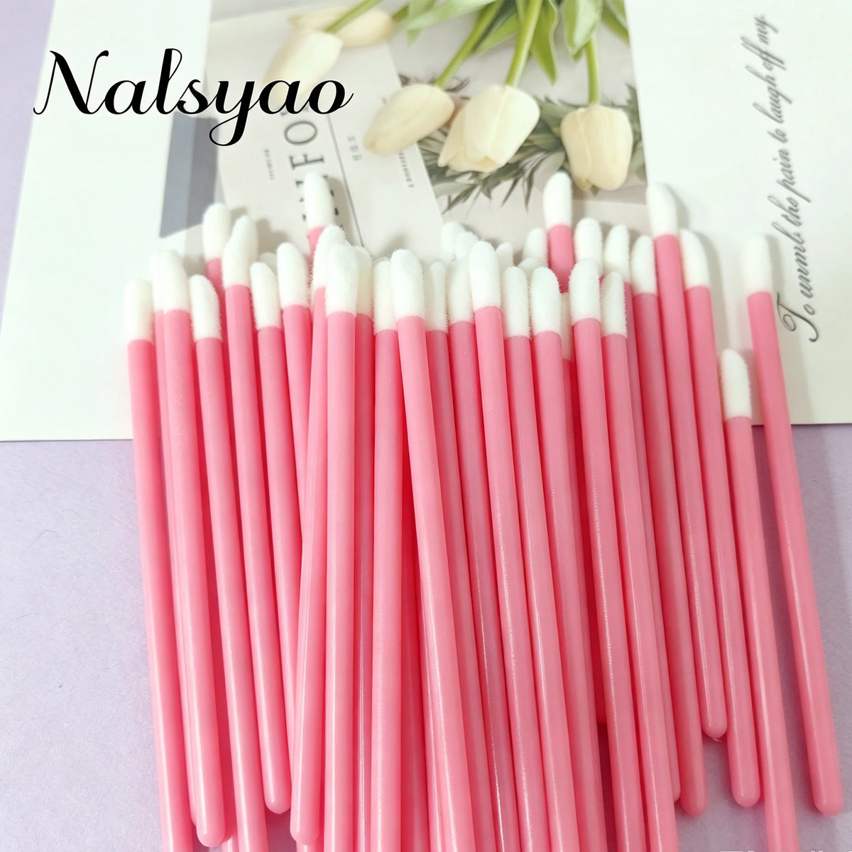 A set of 50 pink and white disposable lip applicator brushes arranged in a vertical line.