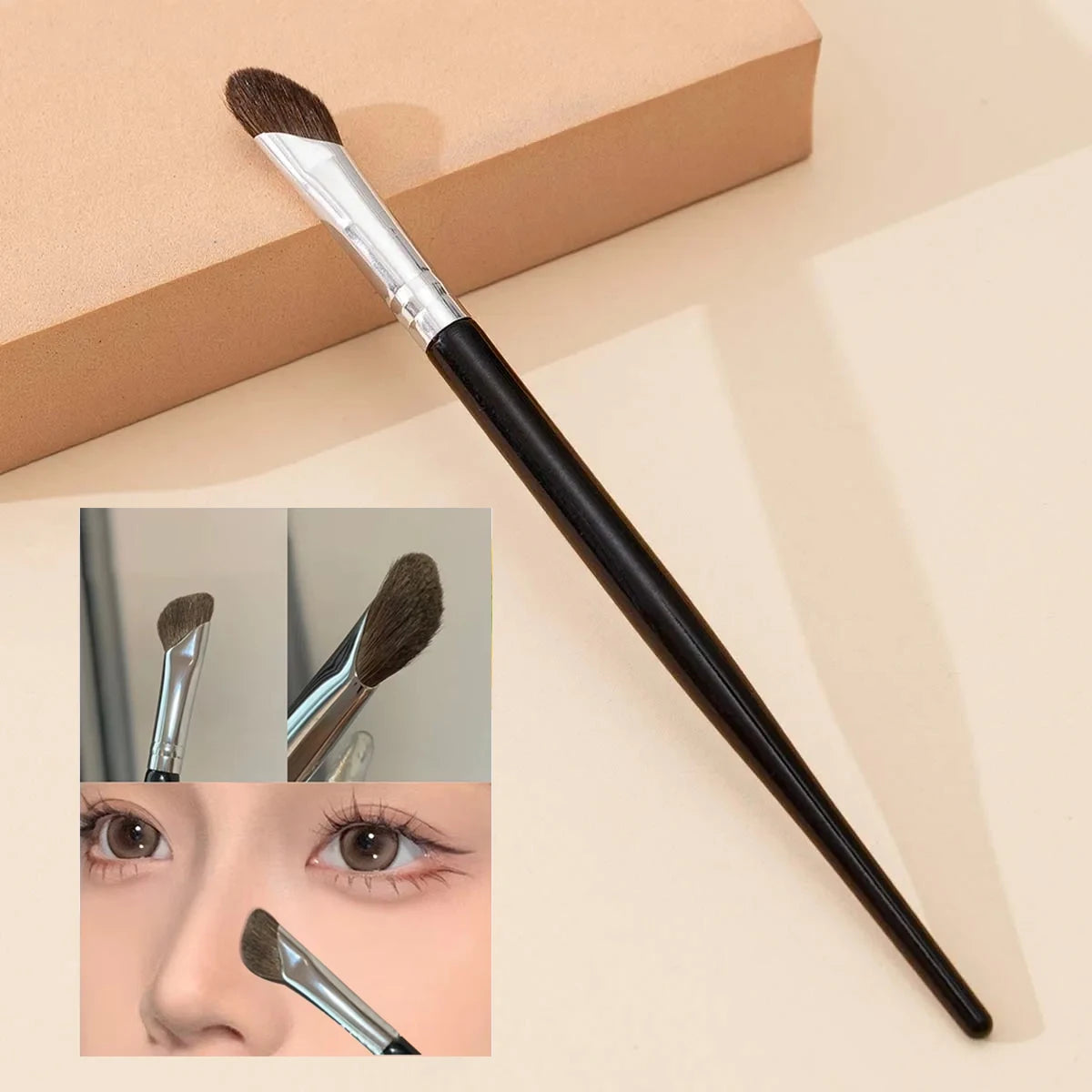 A black makeup brush with a brown synthetic hair is shown next to a beige box and close-ups of its tip and application on the