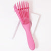 A pink adjustable detangling hair brush with numerous fine bristles is shown on a white background.