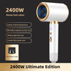 A white 2400W Ultimate Edition hair dryer with a gold accent and blue light feature.