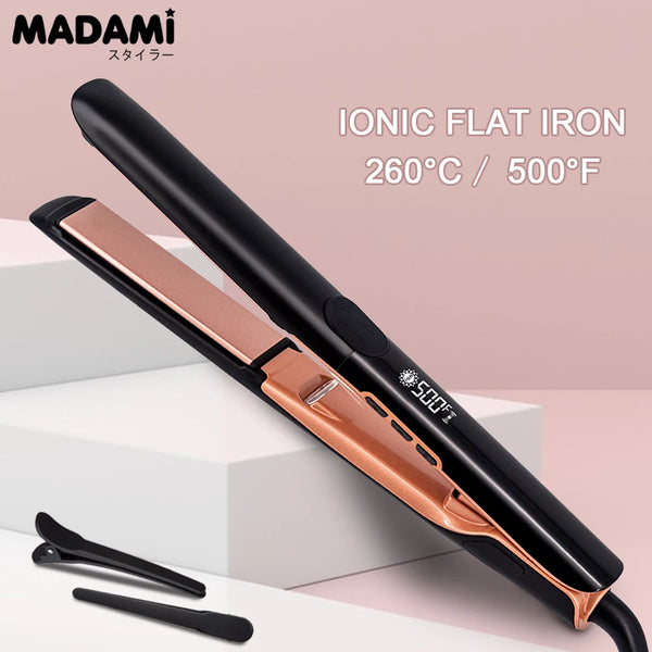A black ionic flat iron with a rose gold finish is shown lying on a white surface.