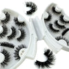 A set of black natural mink striped false eyelash extensions displayed in an open white tray.