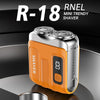 An orange and silver R-18 mini trendy shaver is shown on a dark circular surface.