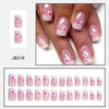 A close-up photo of a hand displaying various press-on acrylic flower nails in pink and white designs.