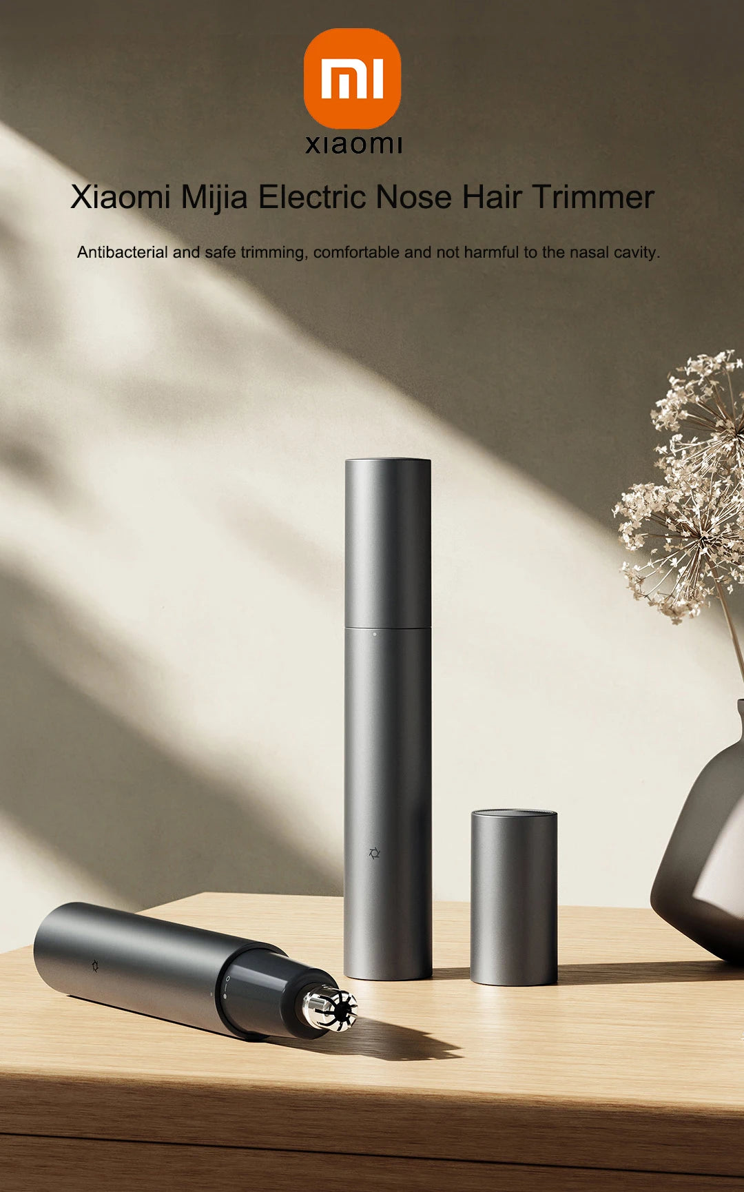 A sleek, black electric nose hair trimmer is shown standing upright next to its detachable head on a wooden surface.
