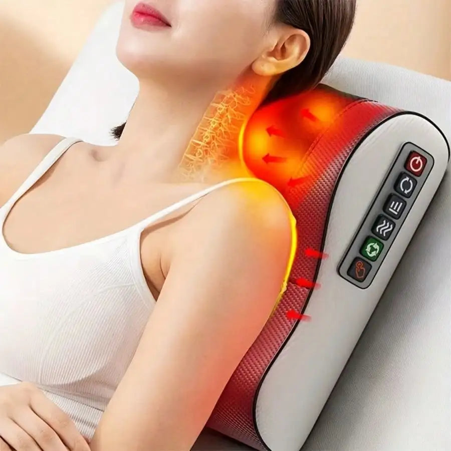 A woman is using a deep kneading massage pillow with soothing heat on her neck and shoulder.