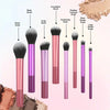 An arrangement of eight makeup brushes with various shapes and colors including blush, foundation, and concealer brushes.