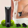 A black multi-purpose body hair trimmer is shown next to green tennis balls and a white towel.