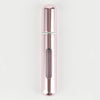A sleek, cylindrical portable refillable perfume bottle with a rose gold finish and silver accents.