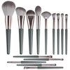 A collection of 14 professional makeup brushes in various sizes and shades, including large foundation brushes and detail bru