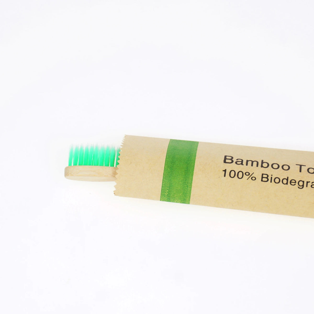 A bamboo toothbrush with green bristles and a green band is shown on a white background.