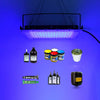 A UV curing lamp illuminates various small bottles of resin and glue activation products against a blue background.
