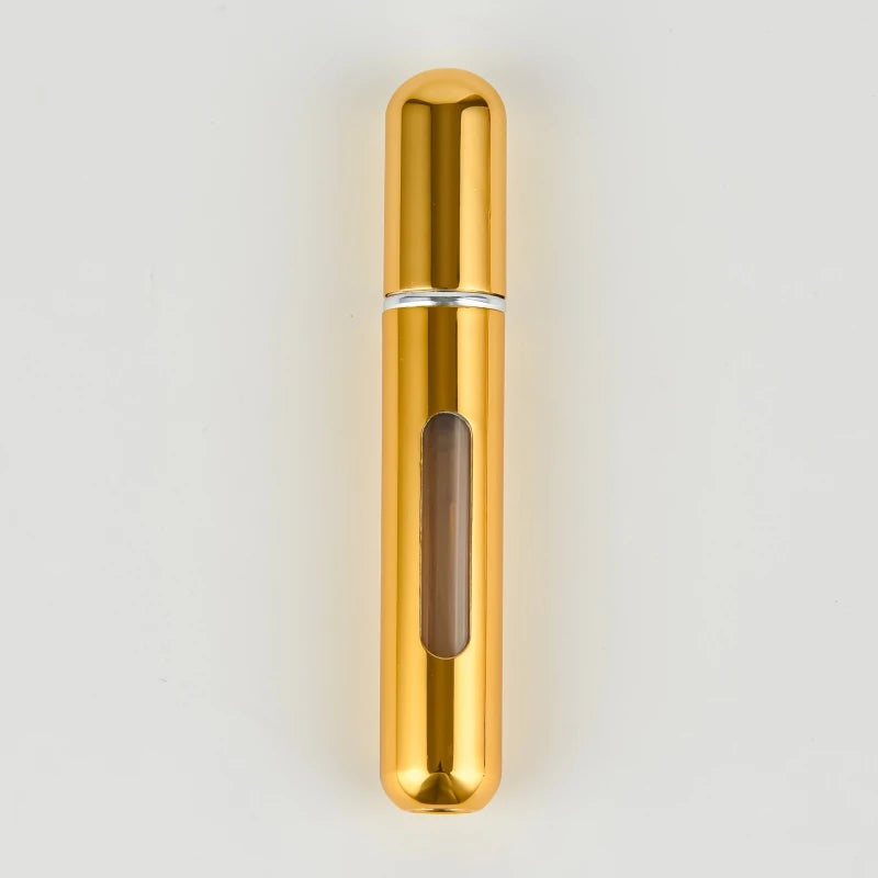 A slender, cylindrical gold-colored perfume bottle with a silver band and a translucent brown liquid inside.