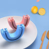 Pink and blue U-shaped food grade brush heads for baby teeth cleaning shown next to citrus fruits