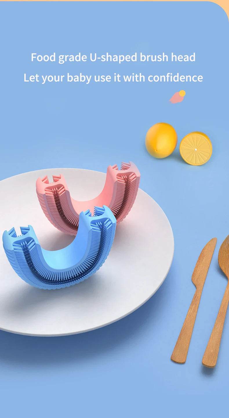 Pink and blue U-shaped food grade brush heads for baby teeth cleaning shown next to citrus fruits