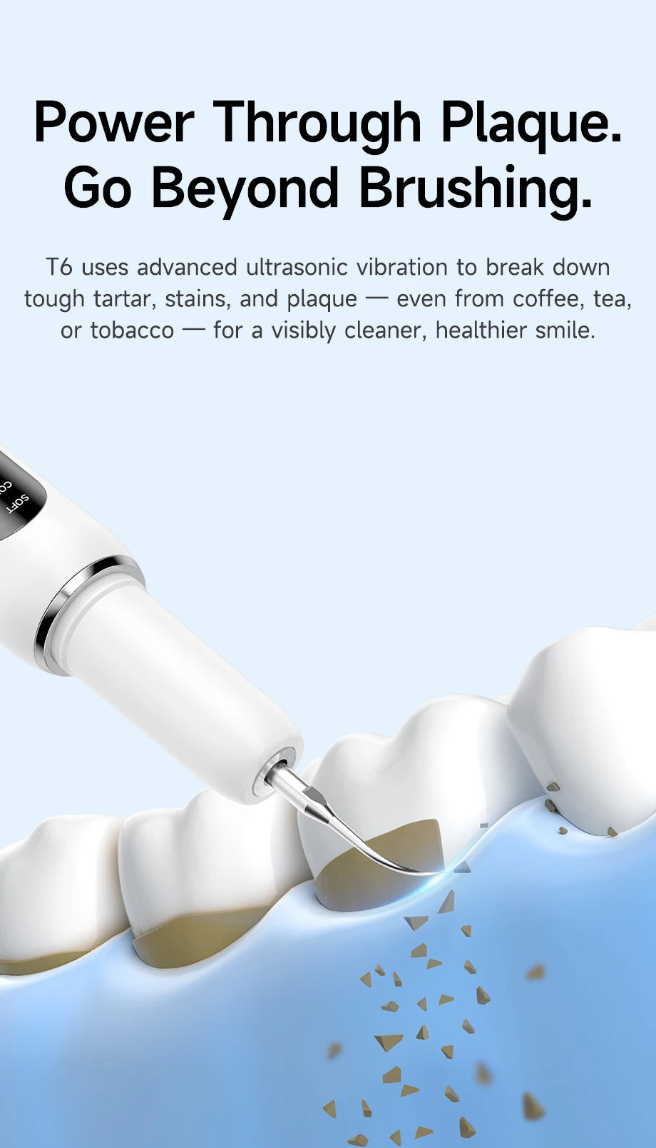 A white ultrasonic teeth cleaning tool is shown cleaning plaque and tartar from a tooth surface.