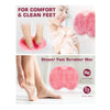 A pink shower foot scrubber mat is shown being used on a person's feet for comfort and clean feet.