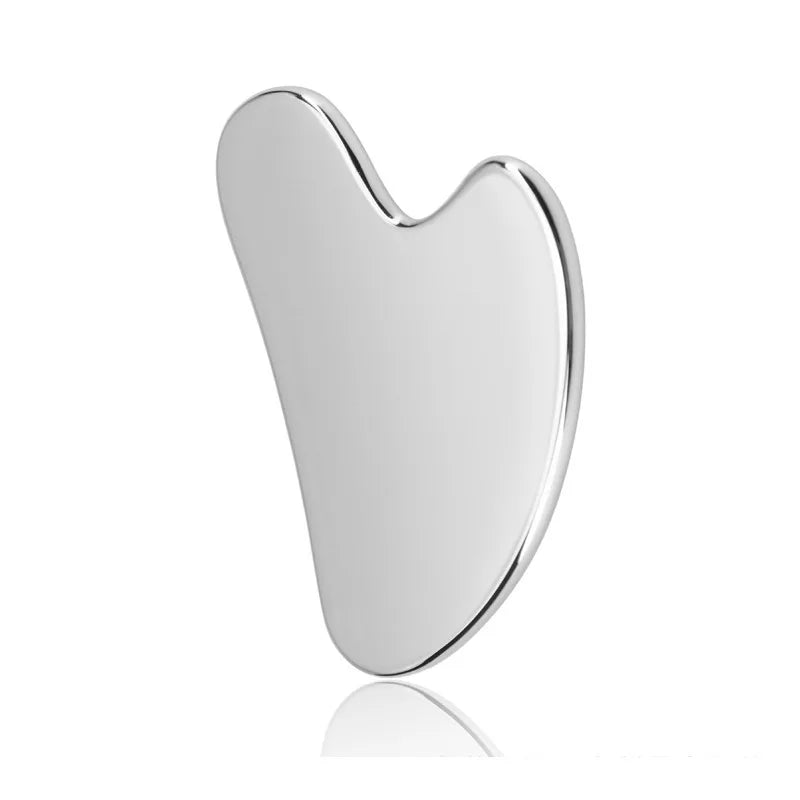 Silver stainless steel gua sha massager tool with a heart-shaped, smooth surface.