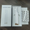 A white box containing an electric razor and accessories for facial hair and peach fuzz removal.