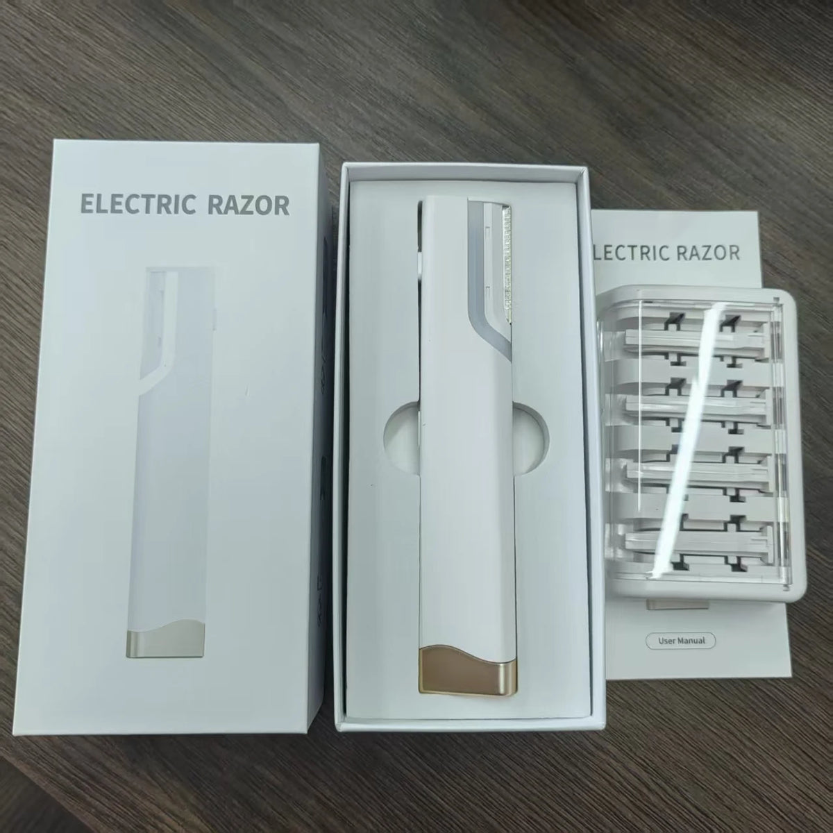 A white box containing an electric razor and accessories for facial hair and peach fuzz removal.