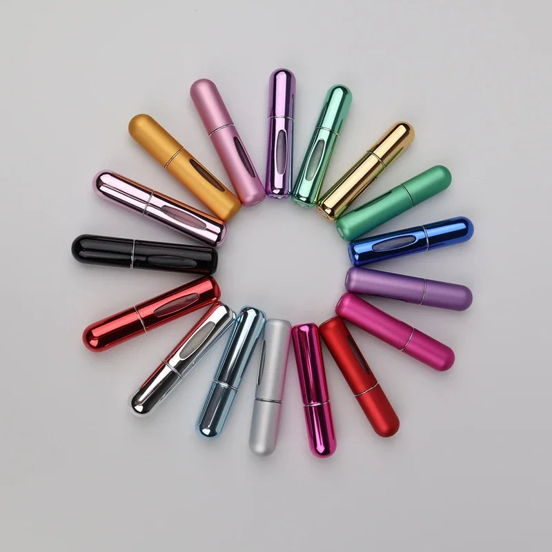 A set of five refillable mini perfume spray bottles in various metallic and pastel colors arranged in a circle.